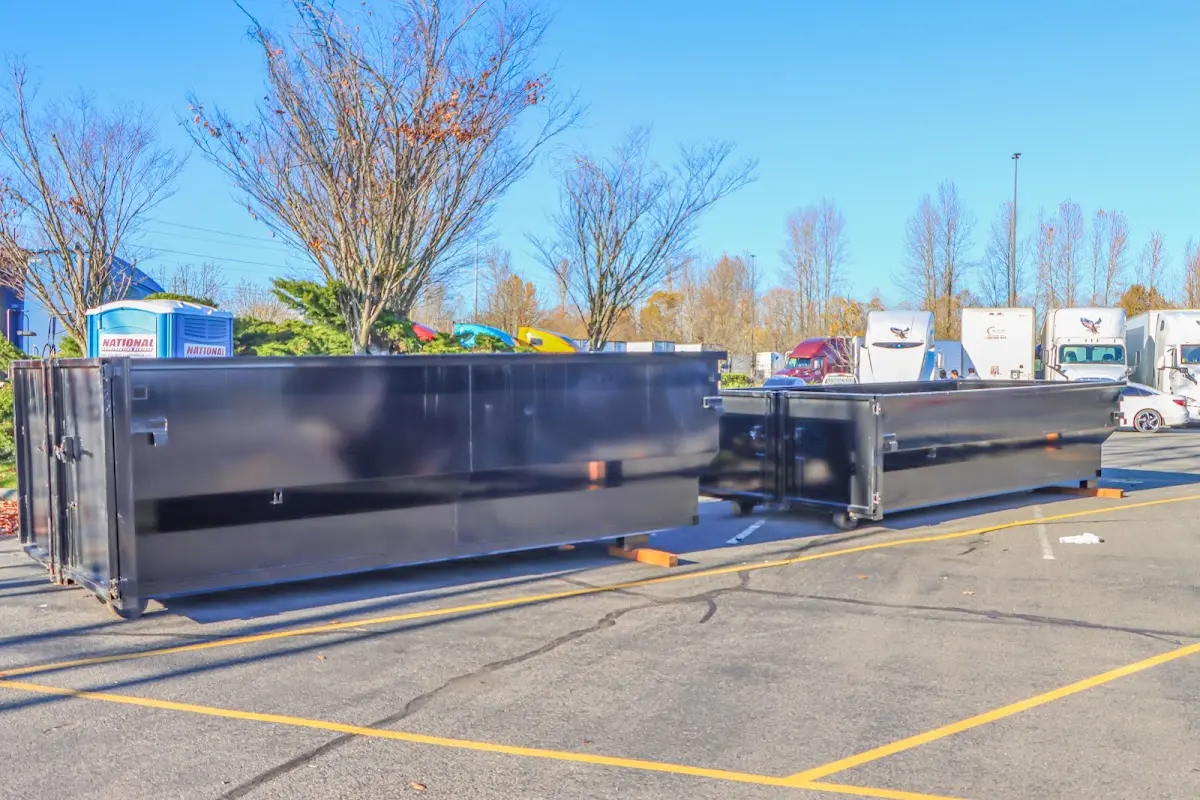Professional dumpster rental service with roll-off container on residential driveway in Atmore